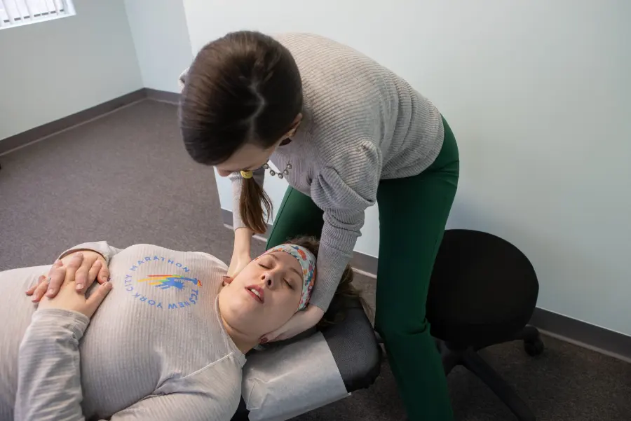 Dr. Jessica adjusting a patient’s neck